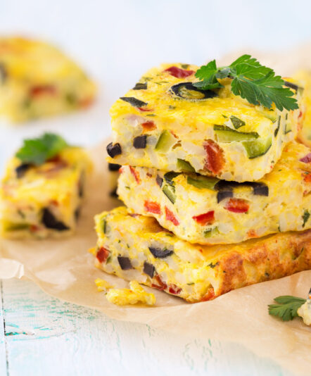 Homemade vegetarian rice frittata with zucchini, bell pepper and olives